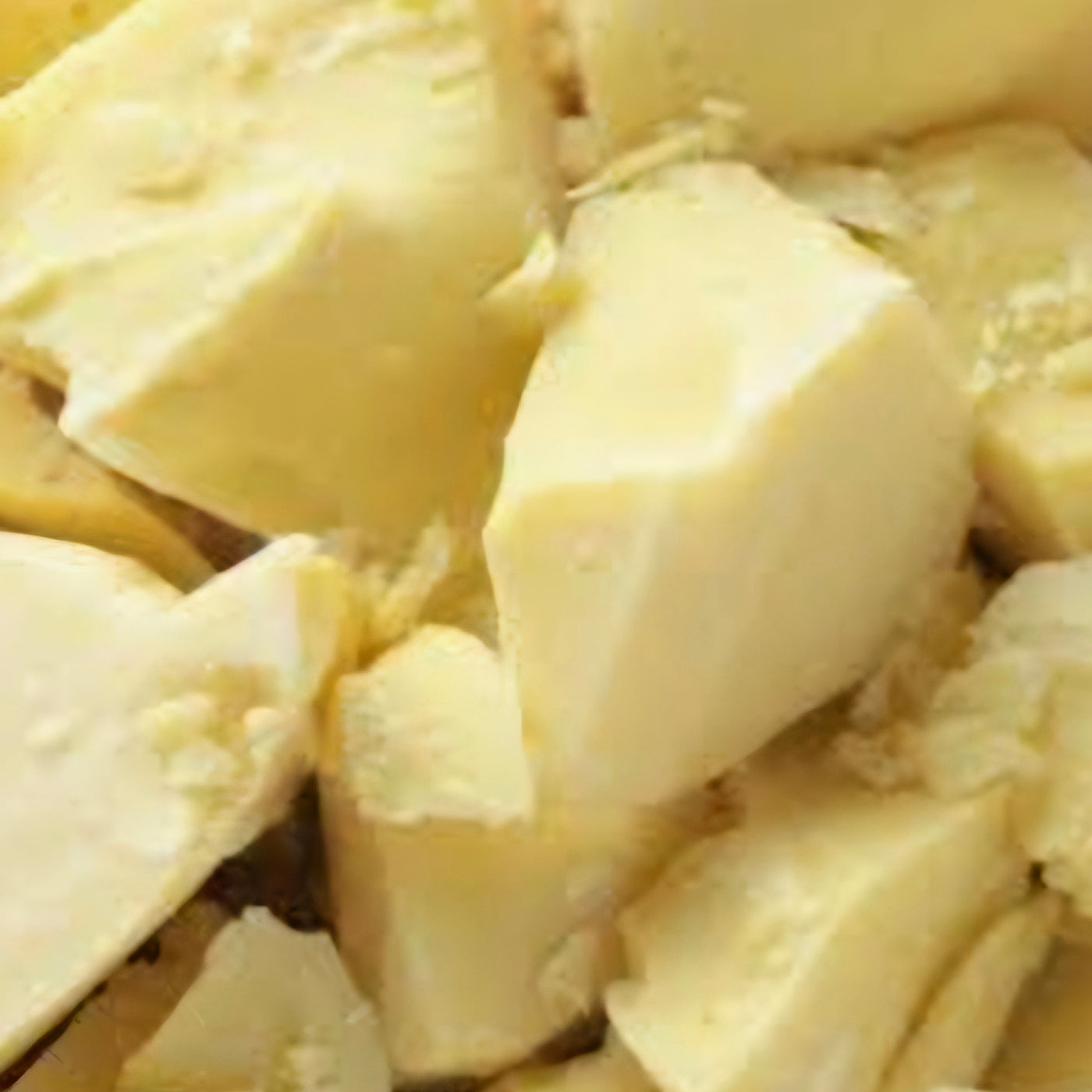 Cocoa butter pieces displayed as a natural skincare ingredient